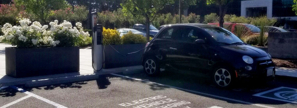 an electric vehicle parked and charging at a charging station